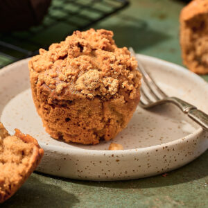 Vegan banana muffin on a plate with a fork