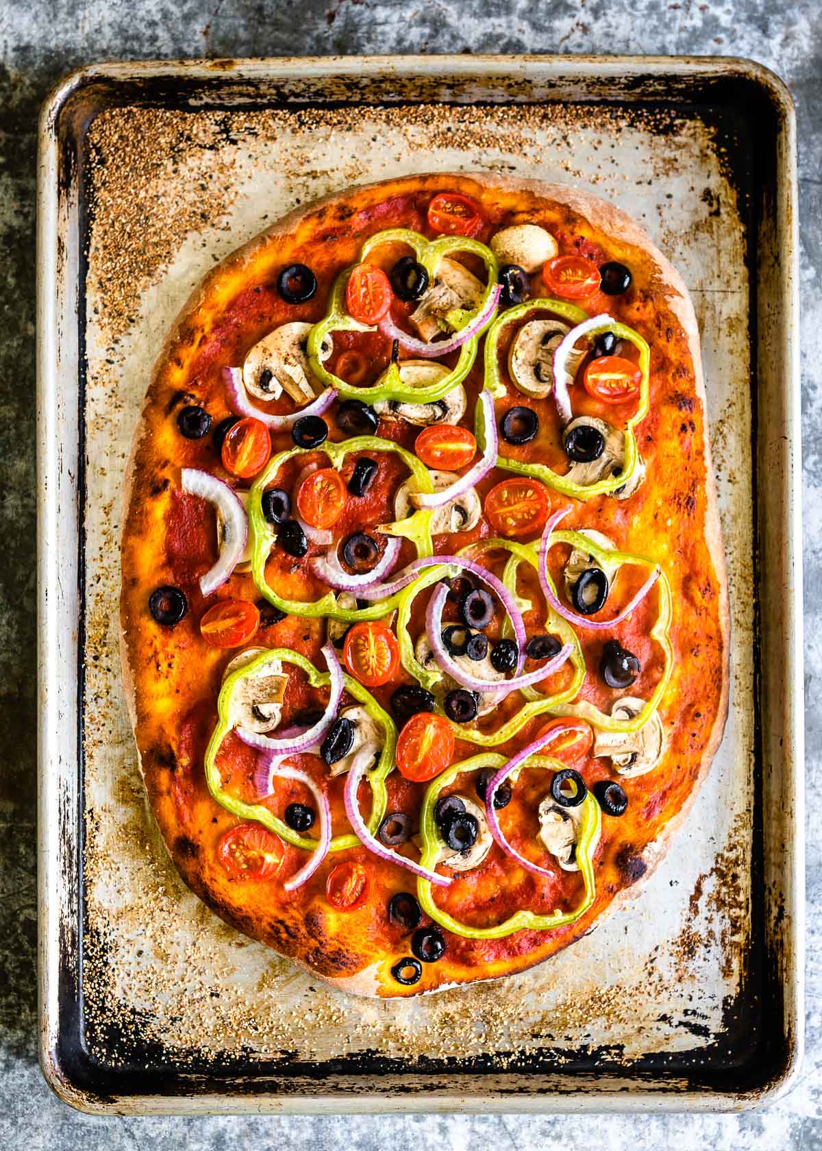A freshly baked vegan pizza on a tray
