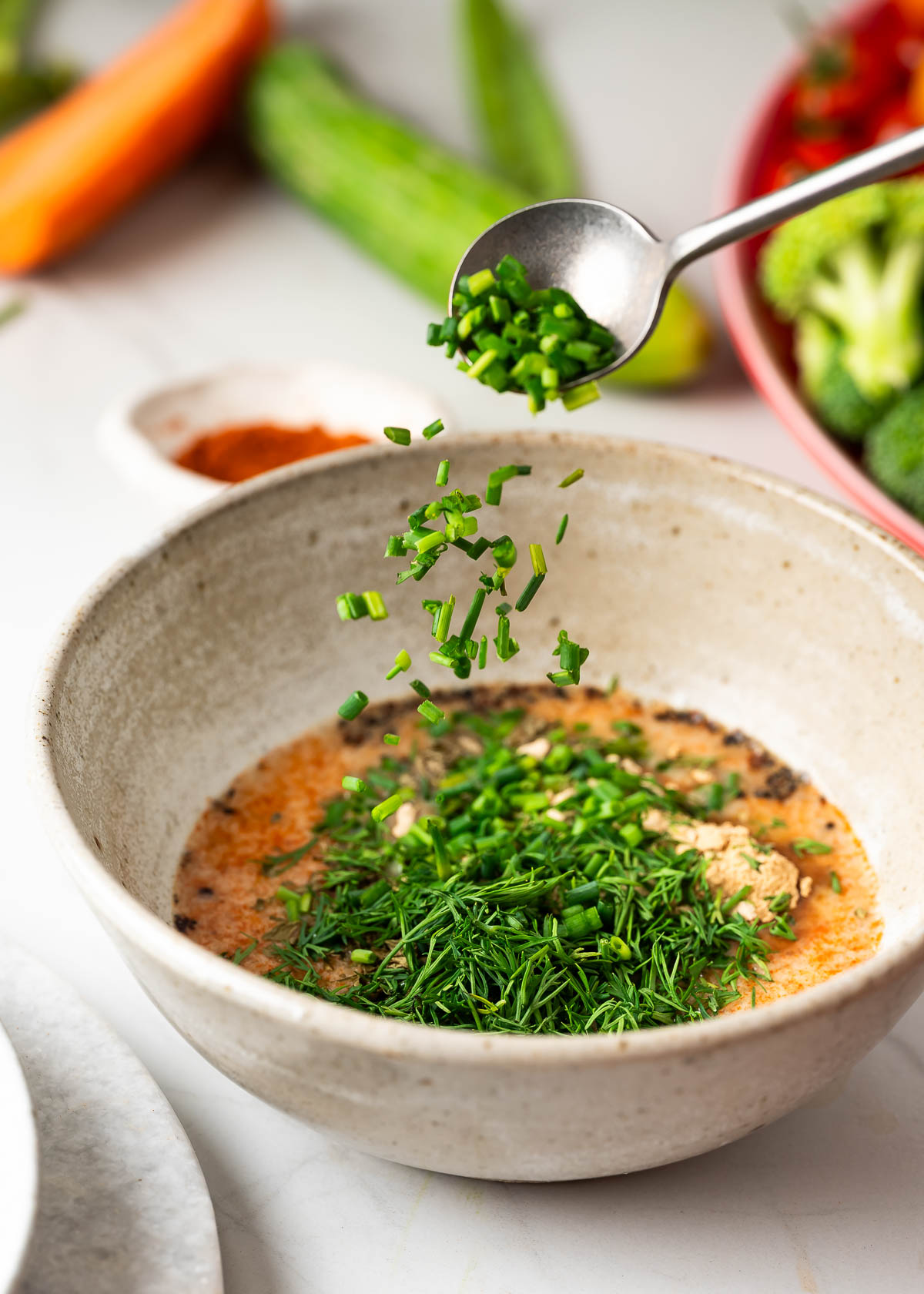 Freshly chopped dill and chives being tossed in the ranch dip mixture. 