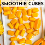 Vitamin C smoothie cubes On a white tray surrounded by various fruits high in vitamin C.