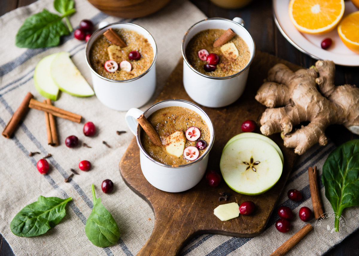 Three white mugs of warm Wassail smoothie.