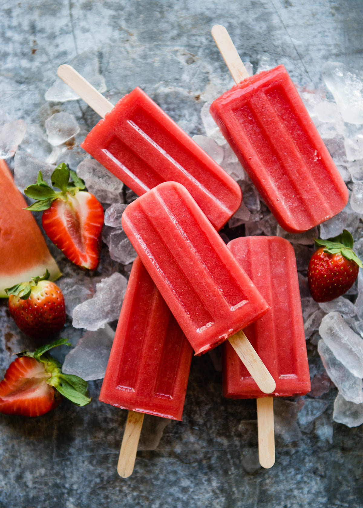 Strawberry watermelon popsicles on a bed of ice