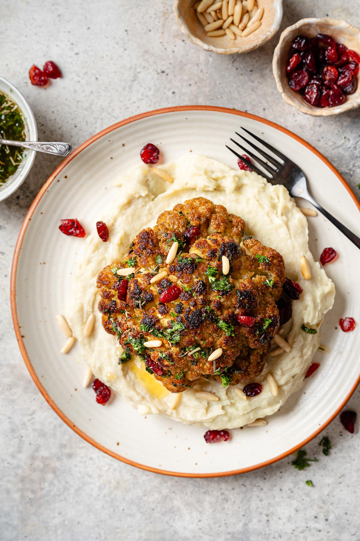 Whole roasted cauliflower on a bed of mashed potatoes