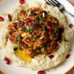 Whole roasted cauliflower on a bed of mashed potatoes