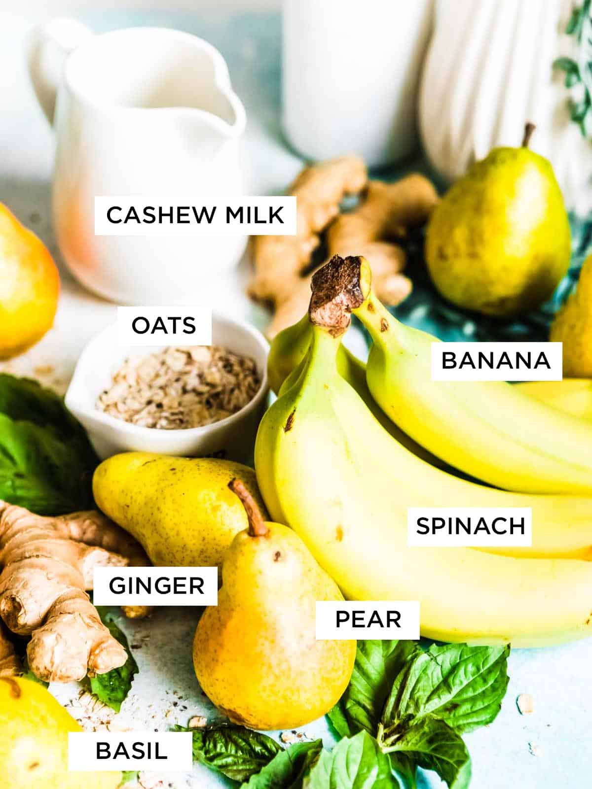 Labeled ingredients for acid reflux smoothie, including cashew milk, spinach, pear, ginger, banana, oatmeal, and basil. 