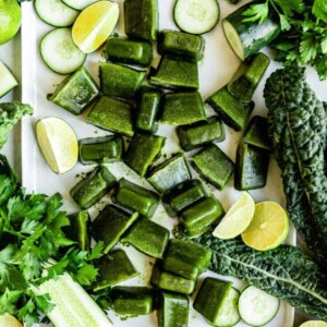 Tray of green produce including limes and cucumbers.