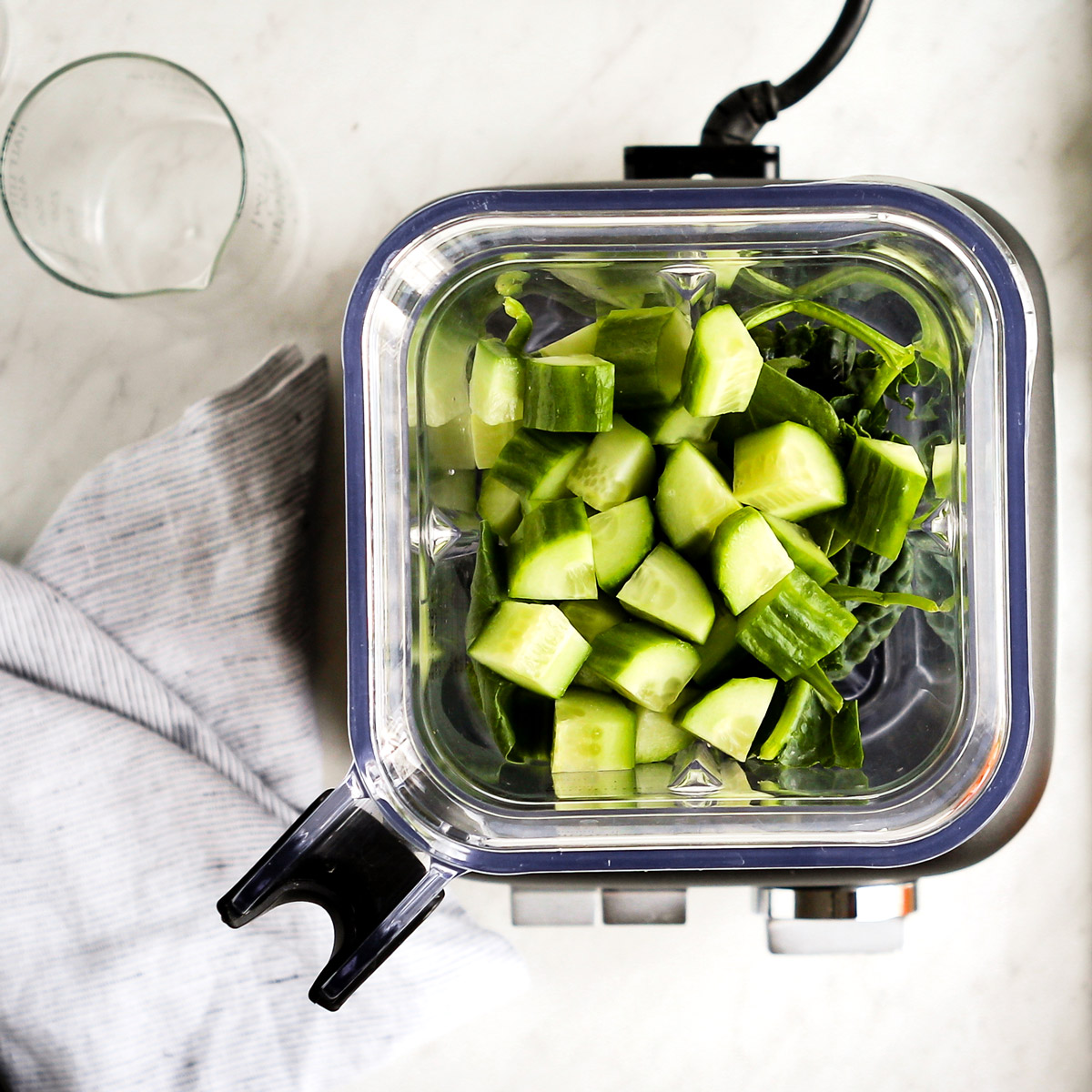 Cucumber and kale in blender to make alkaline smoothie