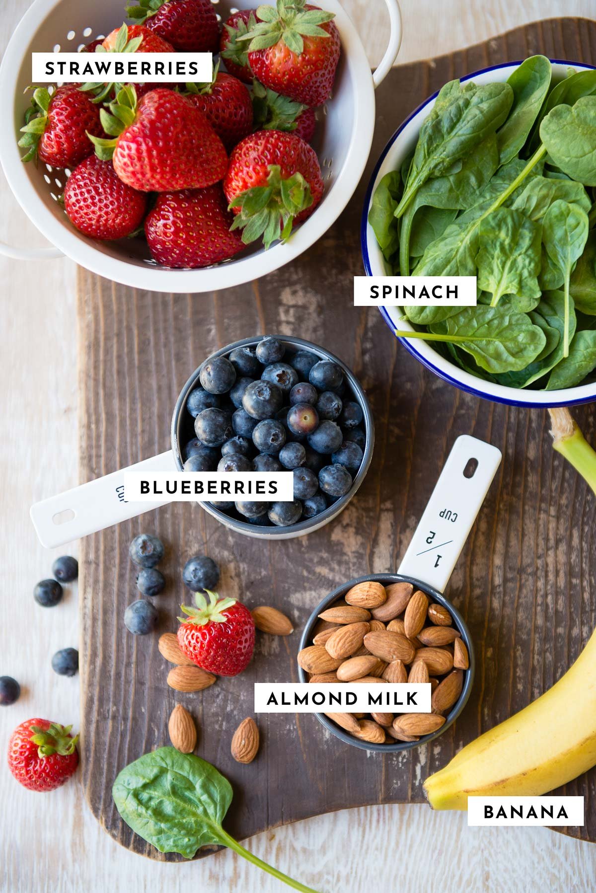 Labeled ingredients for making a berry almond milk smoothie