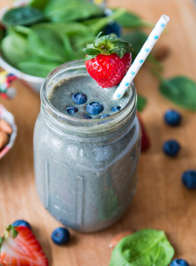 A creamy almond milk smoothie with blueberries and a strawberry on top