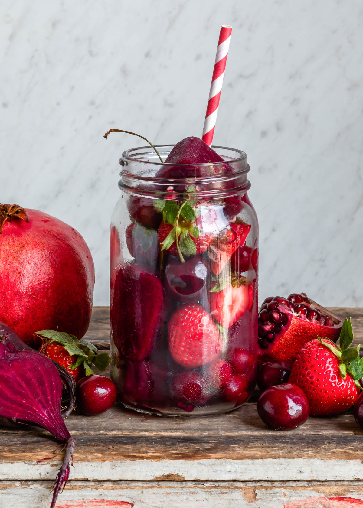Red smoothie cubes featuring pomegranates, cherries, and strawberries.