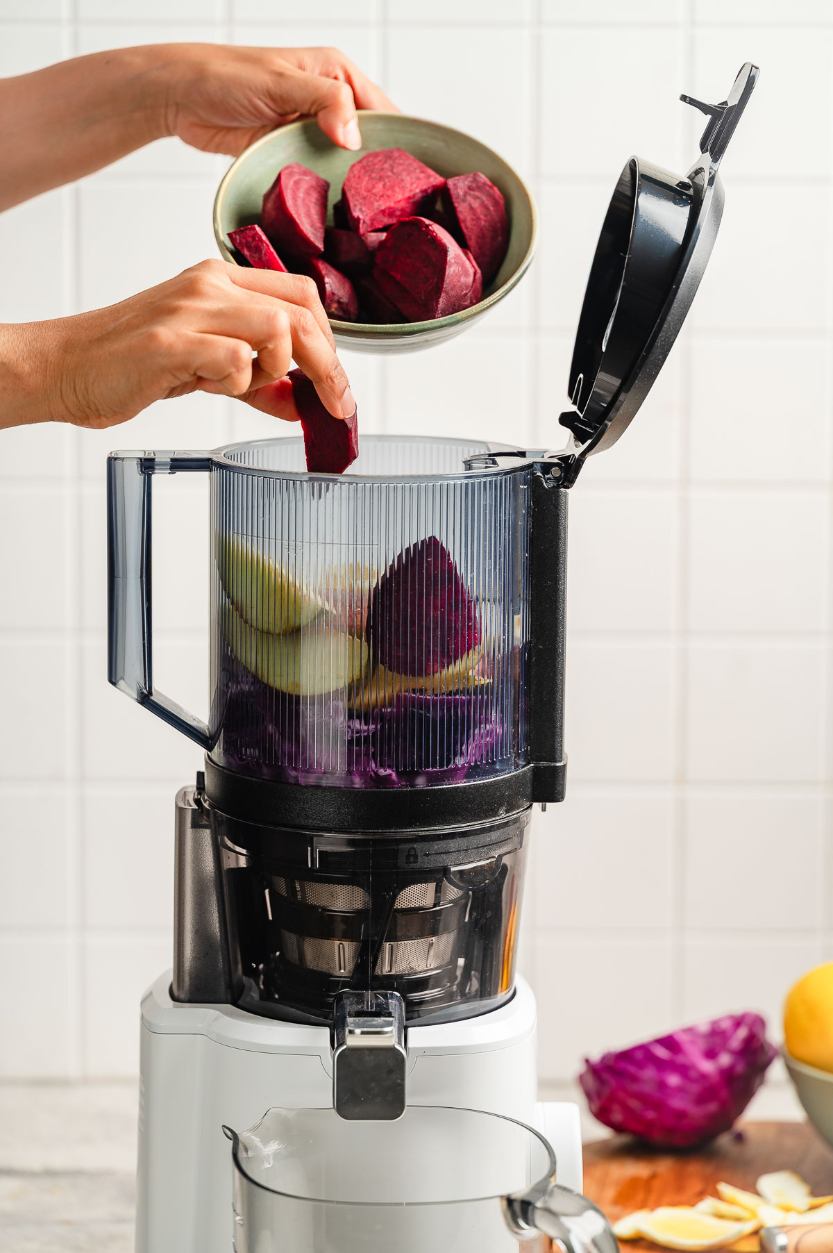 Adding apple beet juice ingredients in a juicer