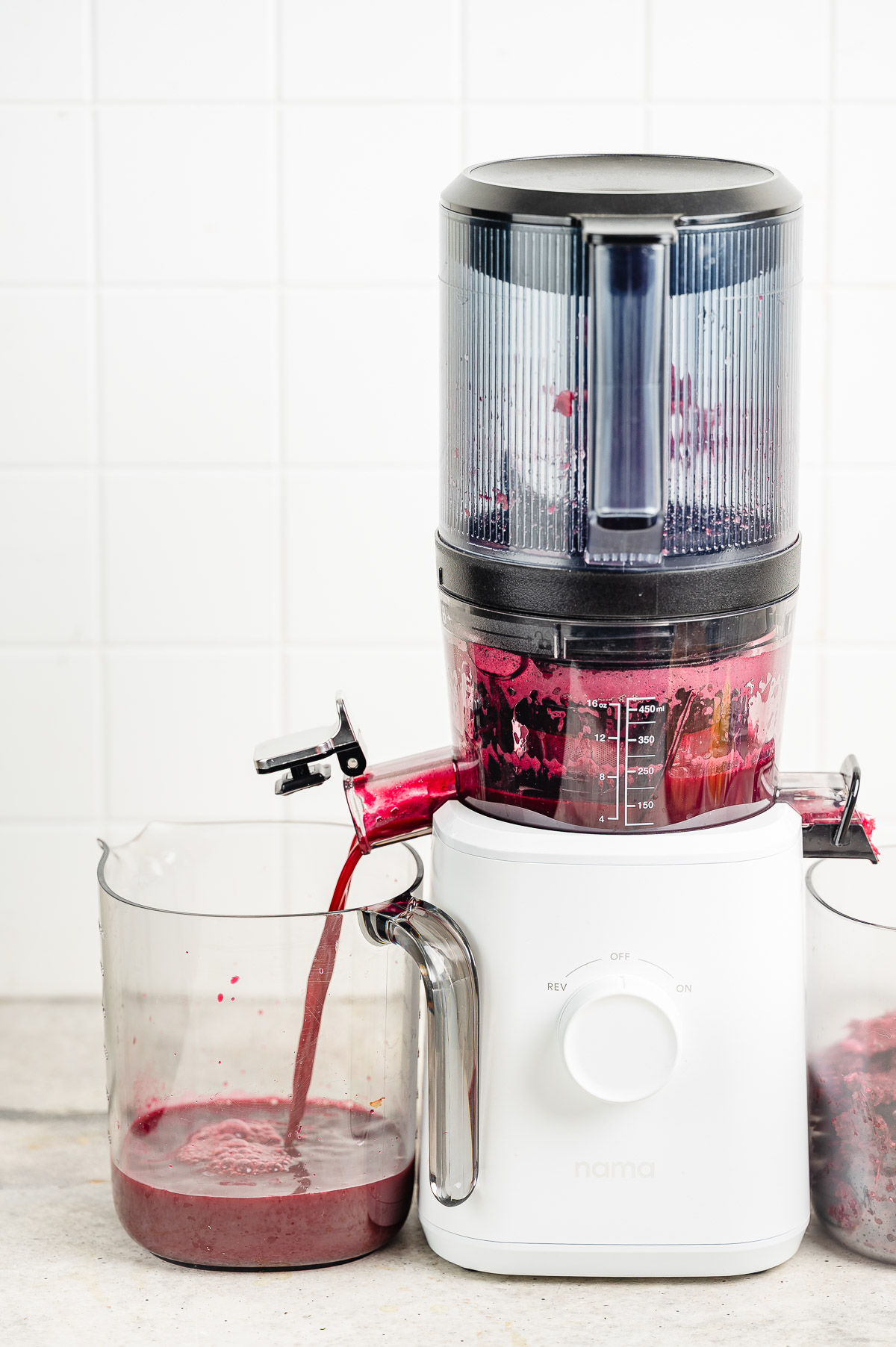 Apple beet juice being juiced into a clear container