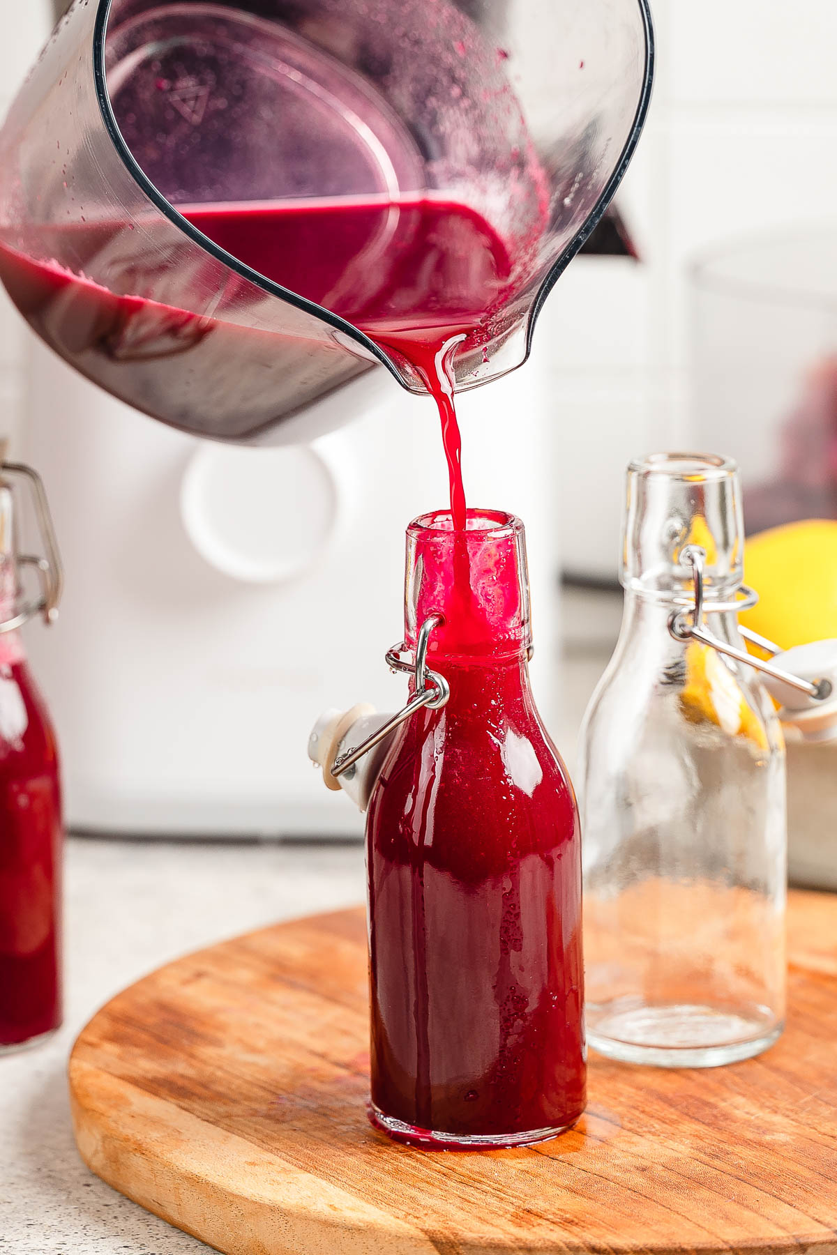 Pouring apple beet juice in a bottle