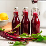 Three bottles of apple beet juice