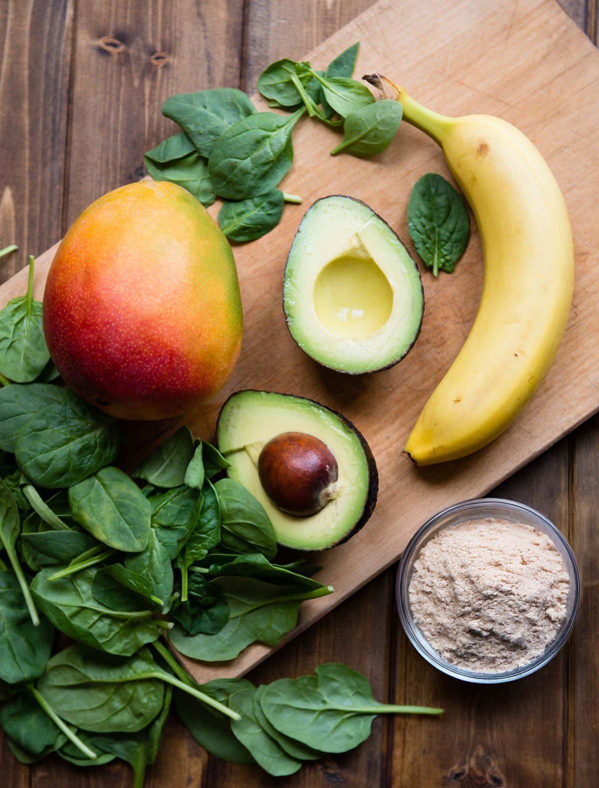 Avocado banana smoothie recipe ingredients on a table.