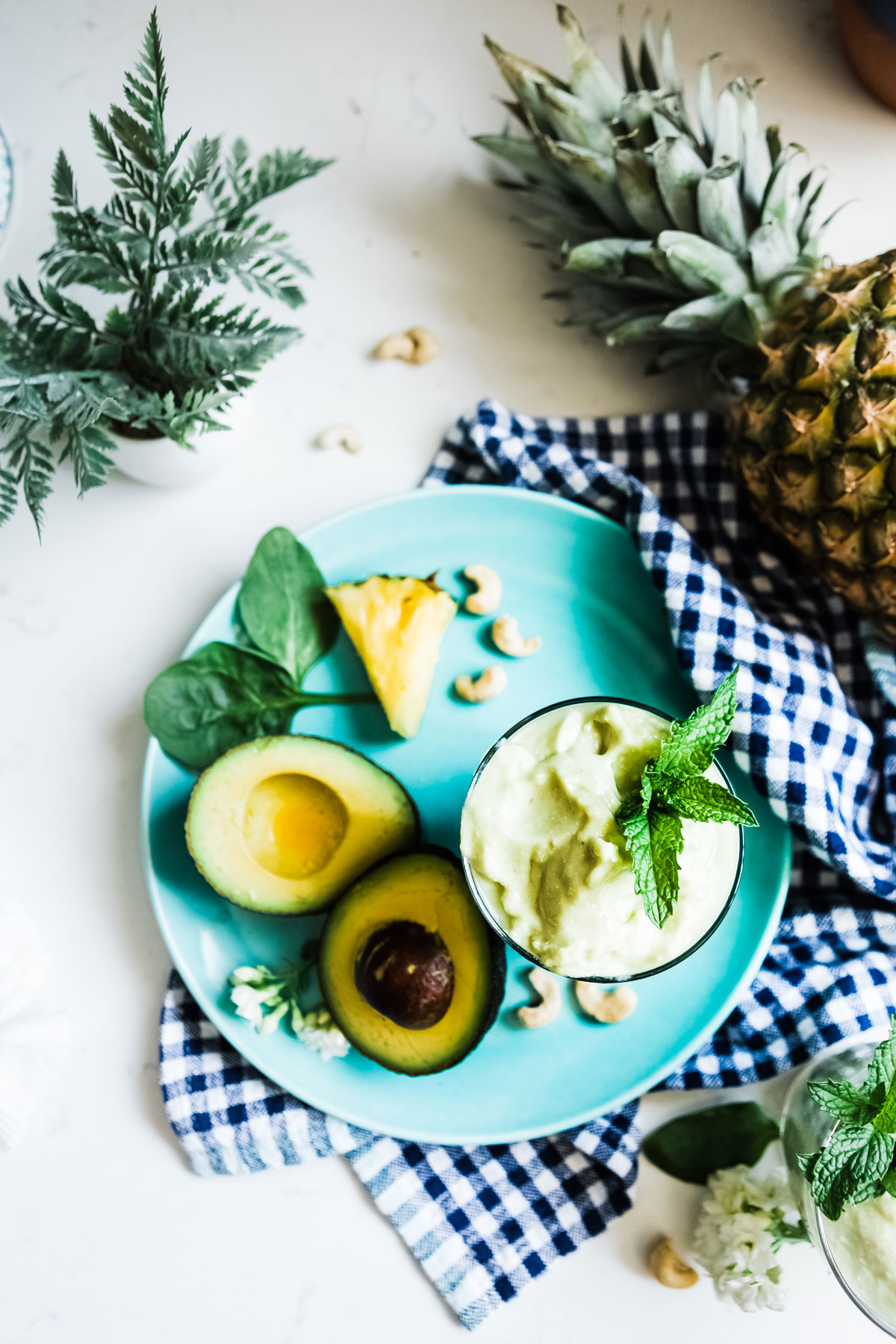 Creamy avocado smoothie recipe in a glass jar, surrounded by fresh ingredients.