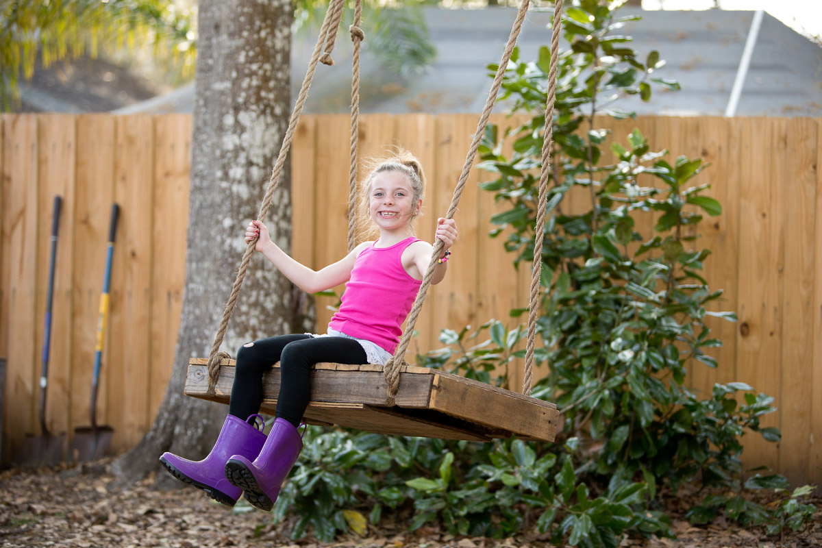 A little girl enjoying a swing.