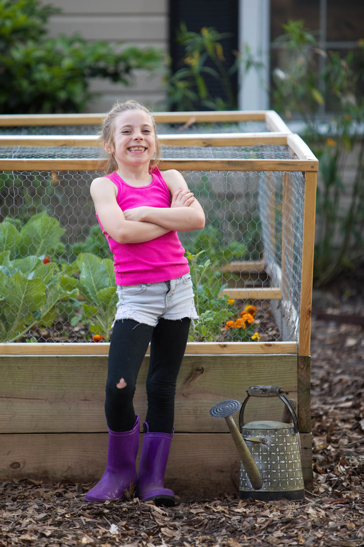 Little girl in front of a homemade raised garden bed