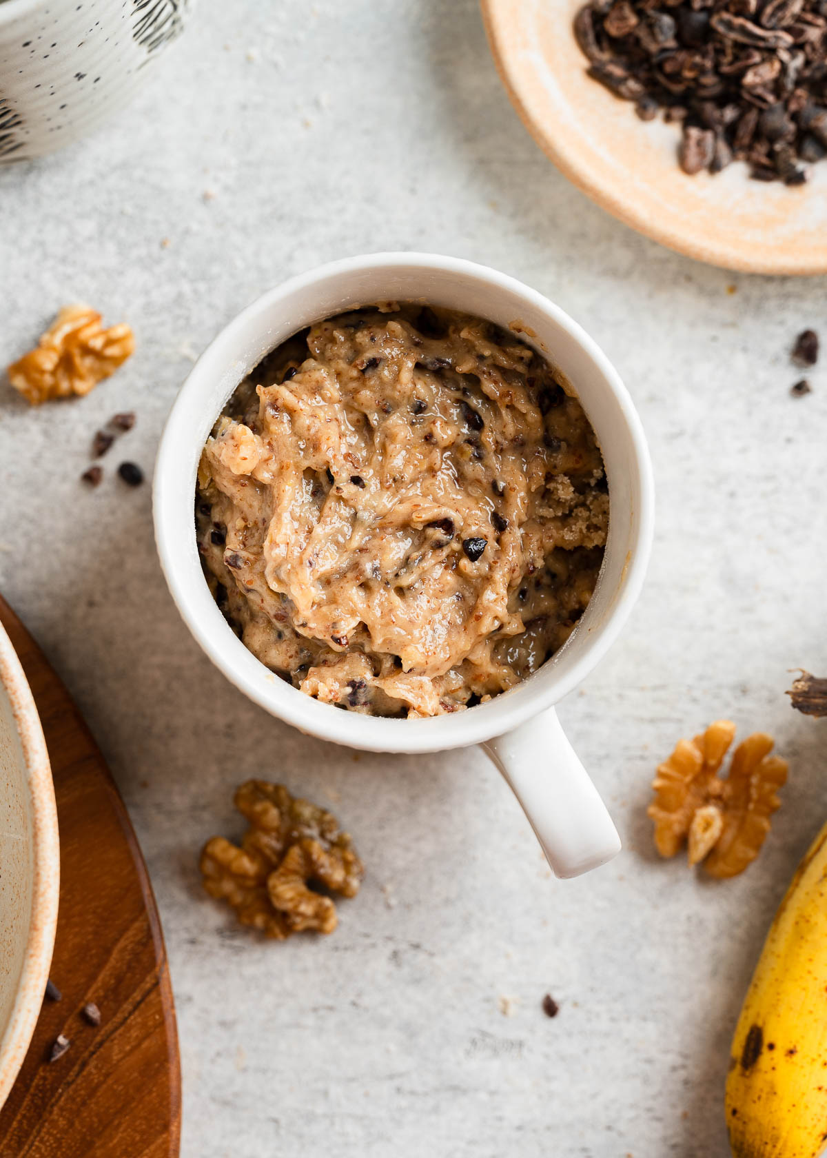 A white mug containing a blended mixture of banana mug cake.