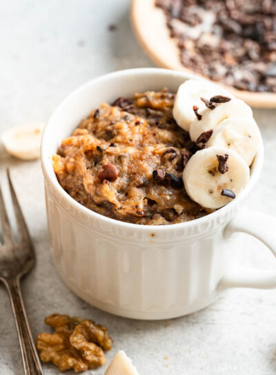 Banana mug cake garnished with slices of banana.