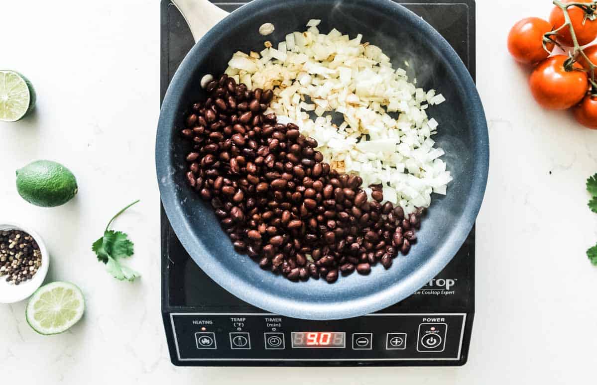 skillet with onions and black beans.