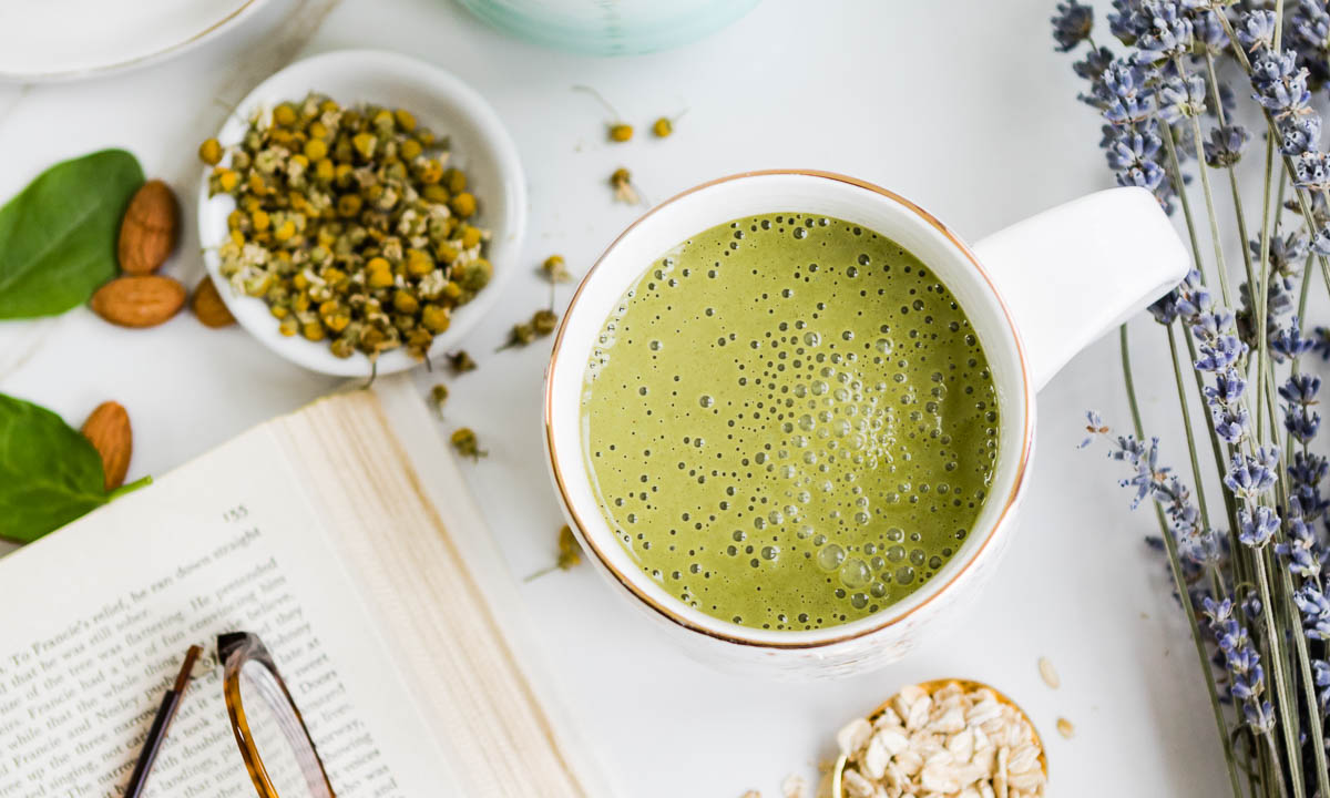 a green smoothie in a white mug to show you how to sleep well.