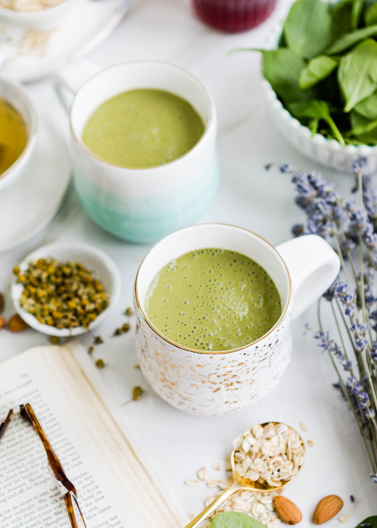 white mug with gold speckles filled with a green bedtime smoothie.