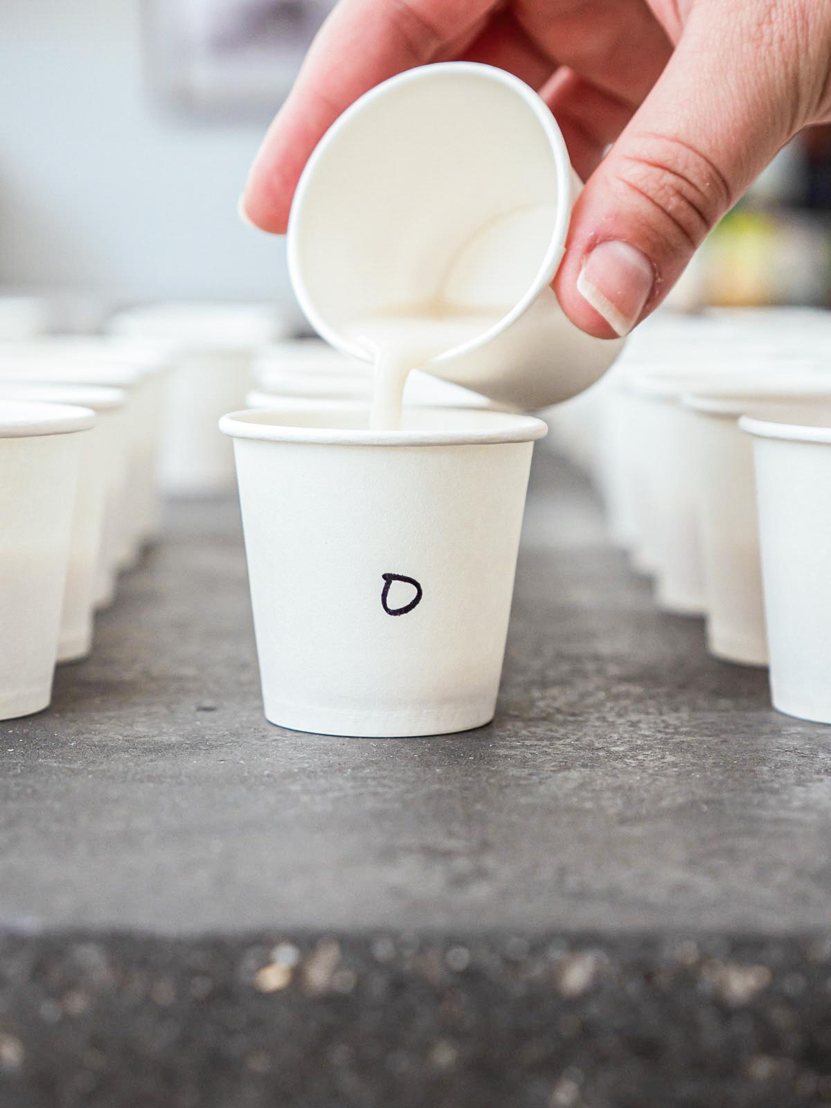 pouring almond milk brand into test cup