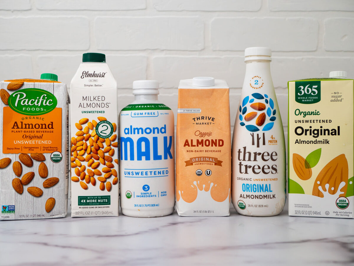 6 cartons of almond milk from left to right: Pacific Foods, Elmhurst, Almond Malk, Thrive Organic Almond, Three Trees Original Almond and 365 Organic Unsweetened Original Almondmilk.