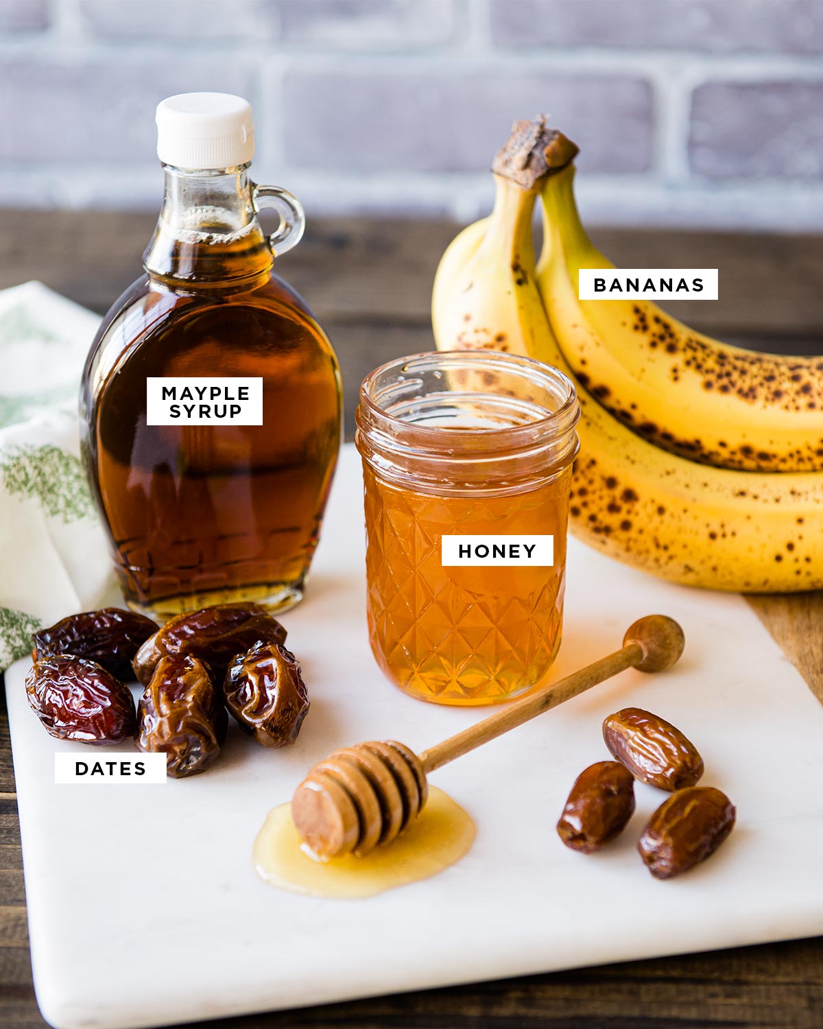 top 4 healthy sugar alternatives labeled: bananas, honey, maple syrup and dates.