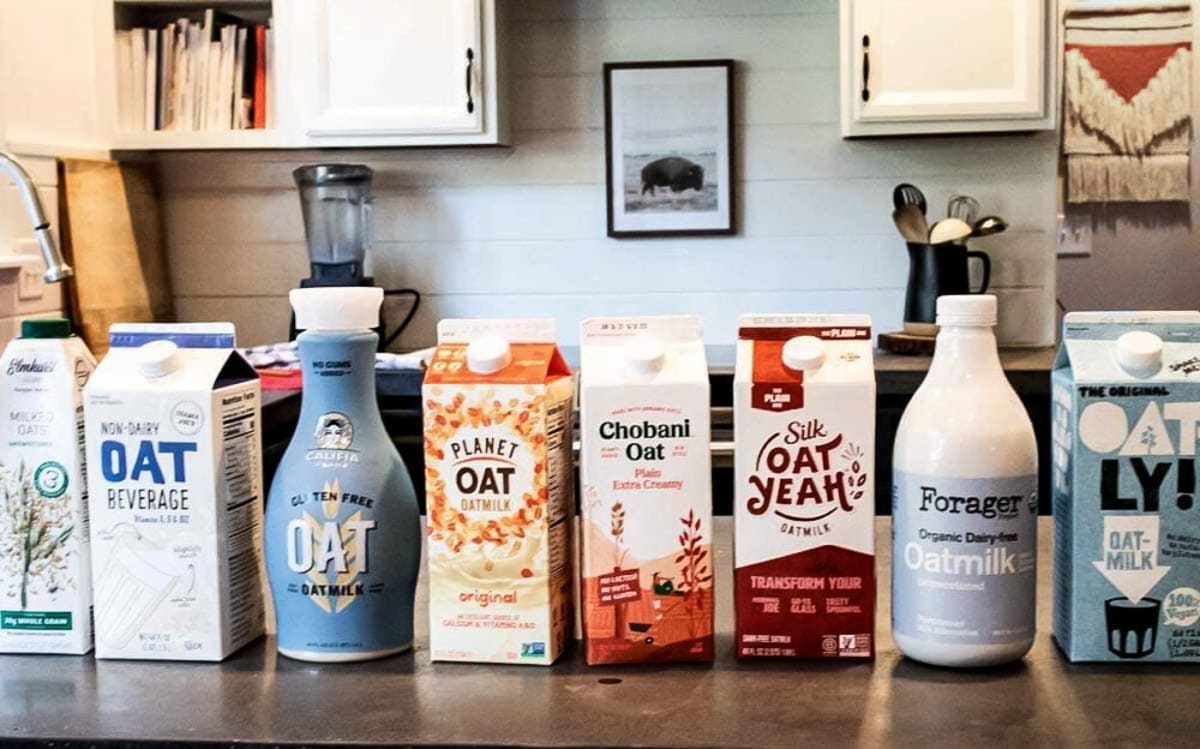 gray countertop lined with 8 dairy-free milk cartons.