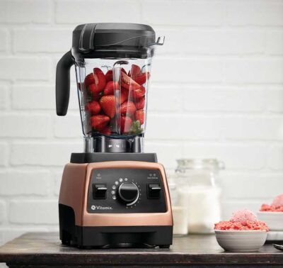 Vitamix blender with strawberries and cherries in a clean kitchen