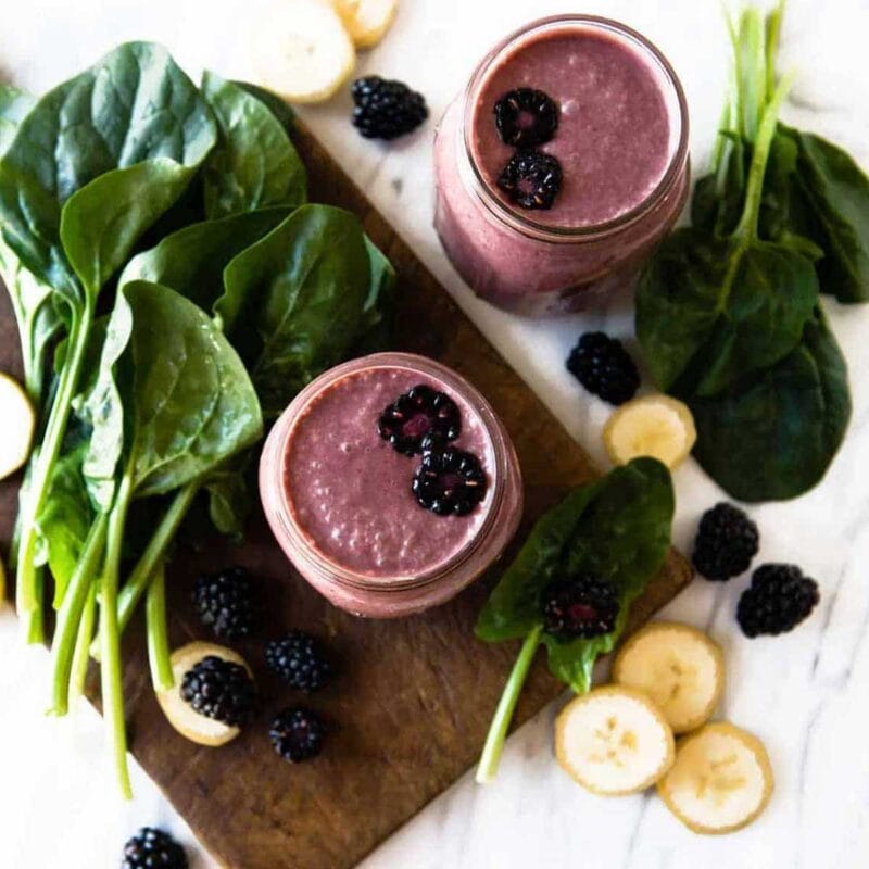 Two jars of creamy blackberry smoothie.