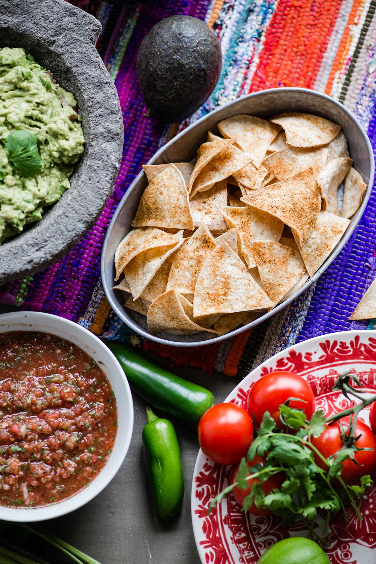 festive table with chips, guacamole and salsa
