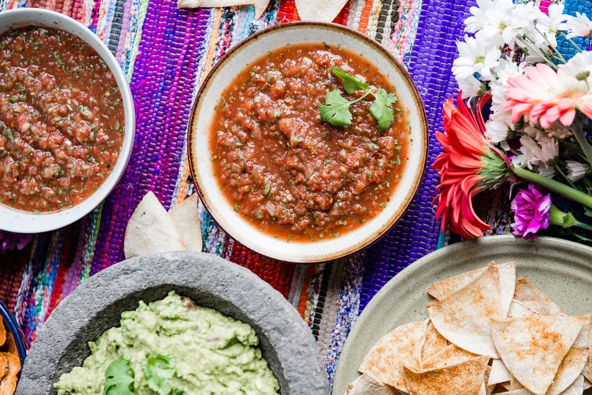table setting with bowls of salsa and tortilla chips
