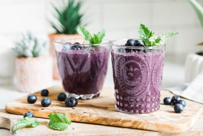 Blueberry smoothie with fresh blueberries and mint.