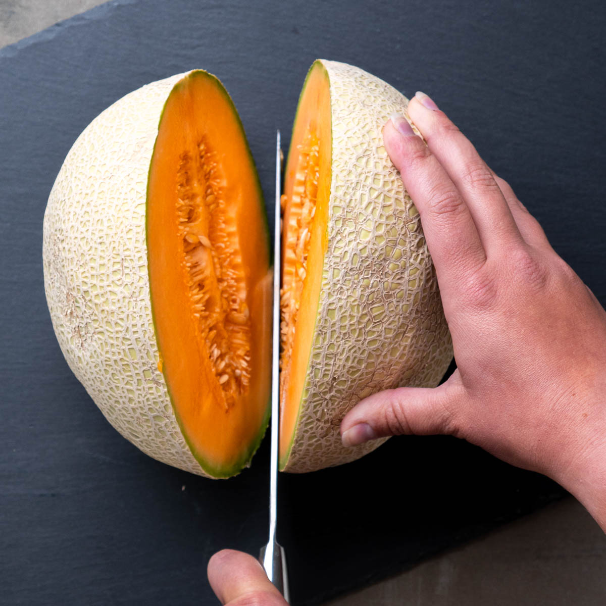 how to cut a cantaloupe steps: cut it in half long ways