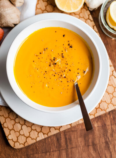 Carrot ginger soup in a white bowl.