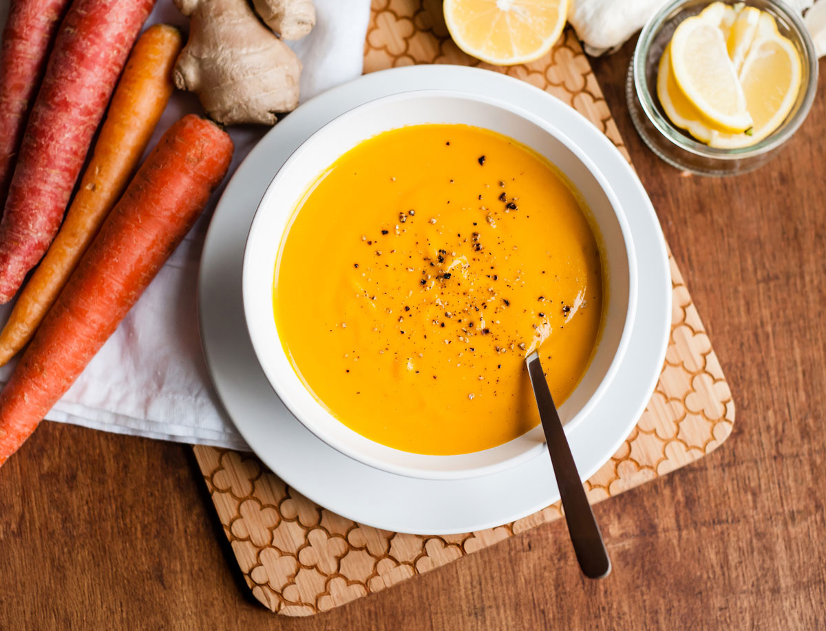 A rich carrot ginger soup topped with cracked black pepper. 