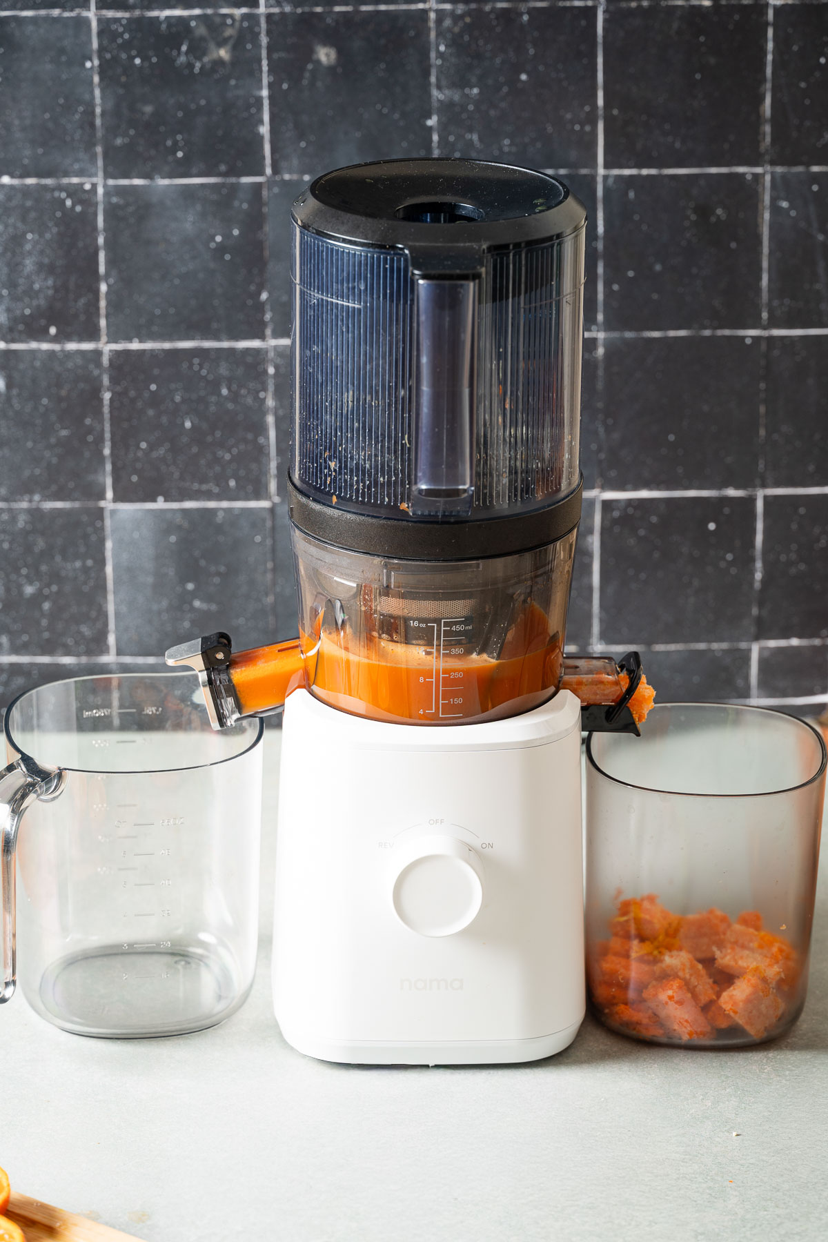 Fresh produce being processed in a juicer