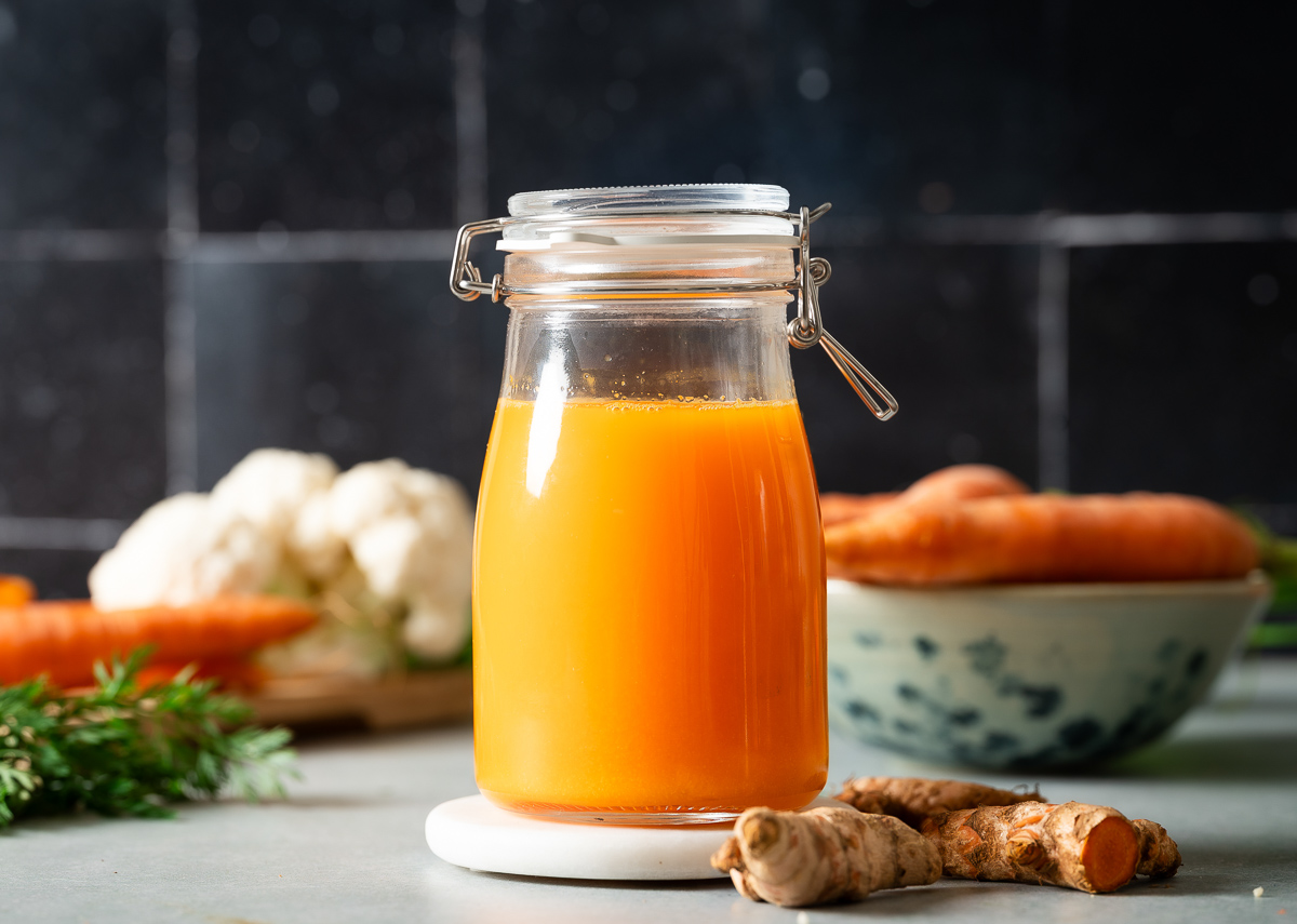 A glass of fresh carrot turmeric juice