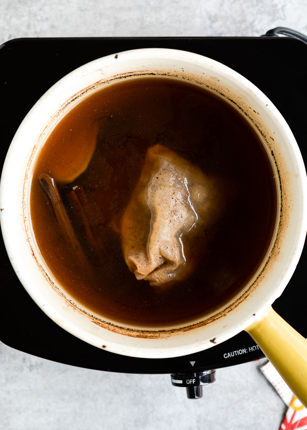 Dark tea base in a saucepan