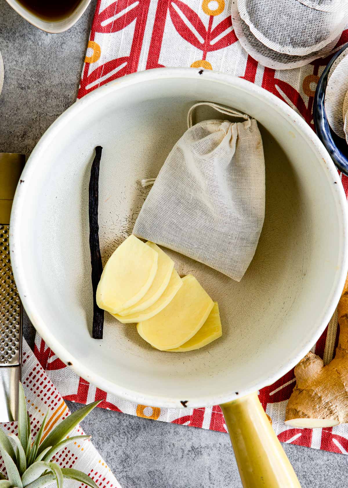 Ginger and a bag of spices in water