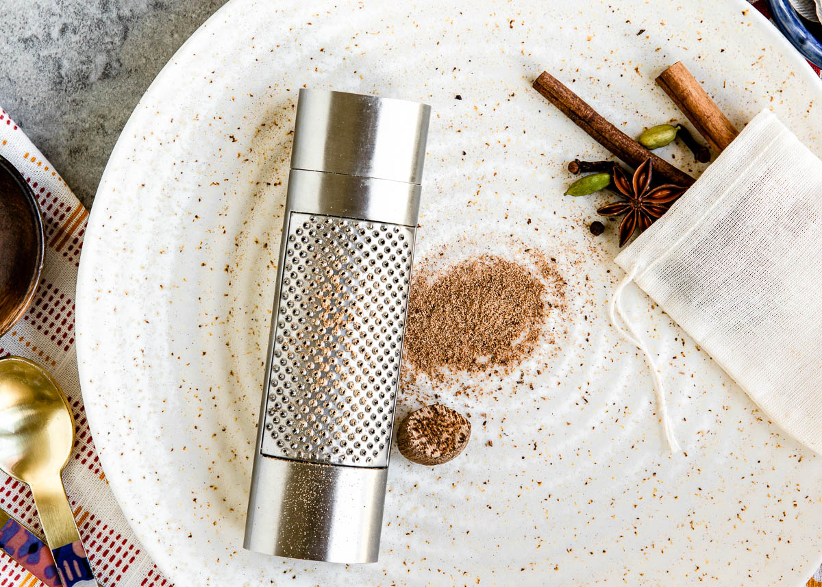 Freshly grated spices on a plate with a grater