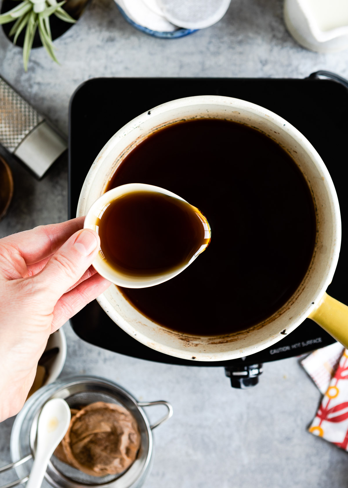 Pouring maple syrup into the chai tea base