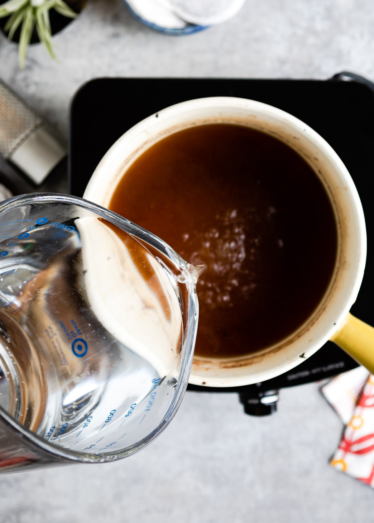 Adding water into the chai tea base