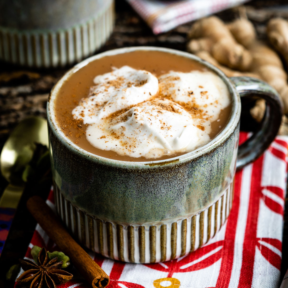 A cup of chai latte with whipped coconut cream on top