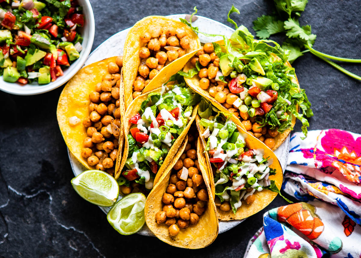 overhead shot of 6 chickpea tacos loaded with pico de gallo and lettuce