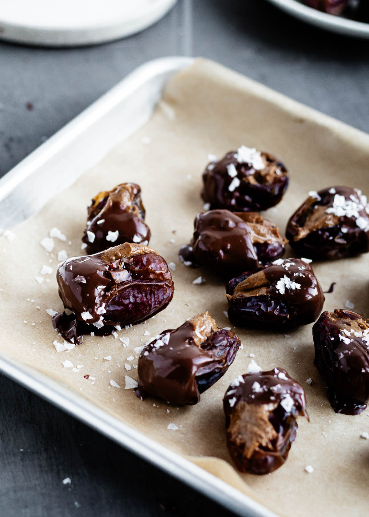 Chocolate covered dates on parchment paper. 