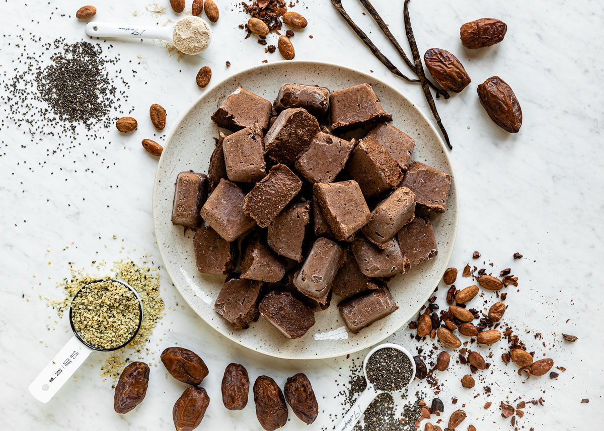 plate of chocolate smoothie cubes surrounded by various brown ingredients.